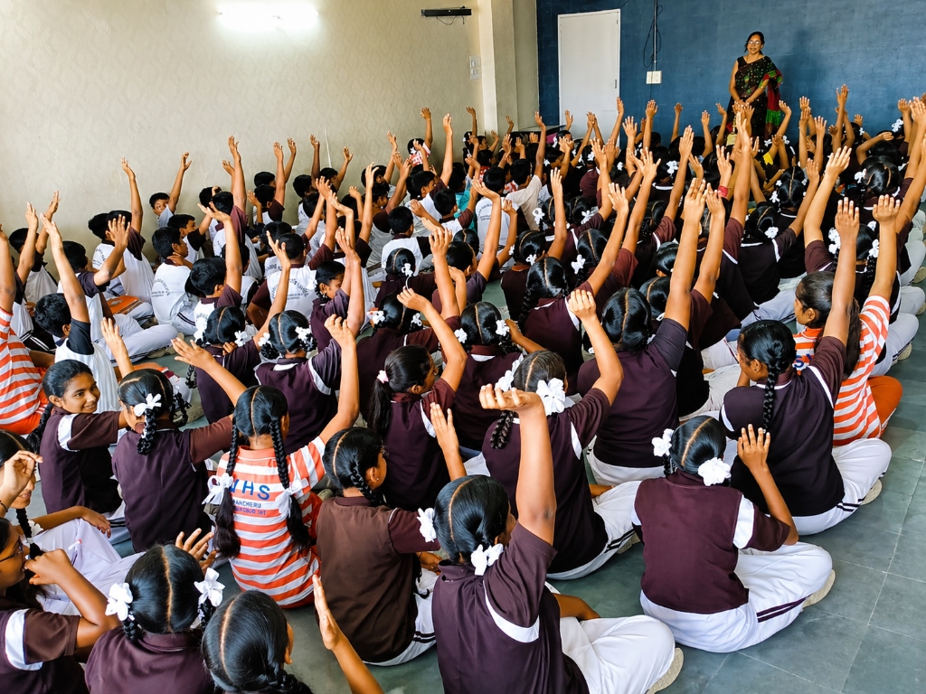 Students raising hands to answer questions